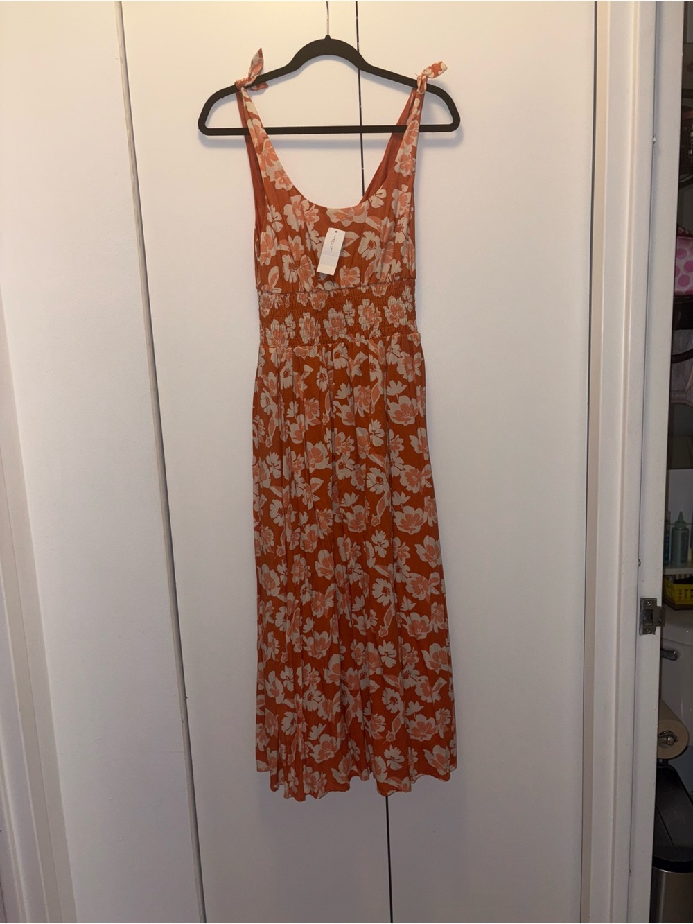 American Eagle Smocked Tie-Strap Midi Dress in an orange and white floral print.
